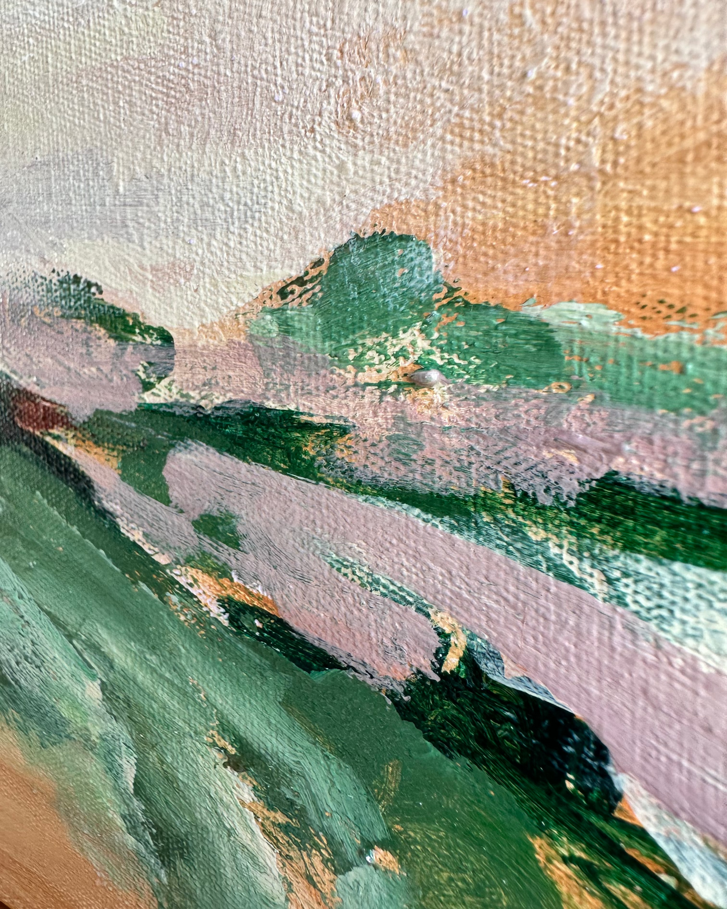 Close-up of a painting with green and brown hues on a textured surface
