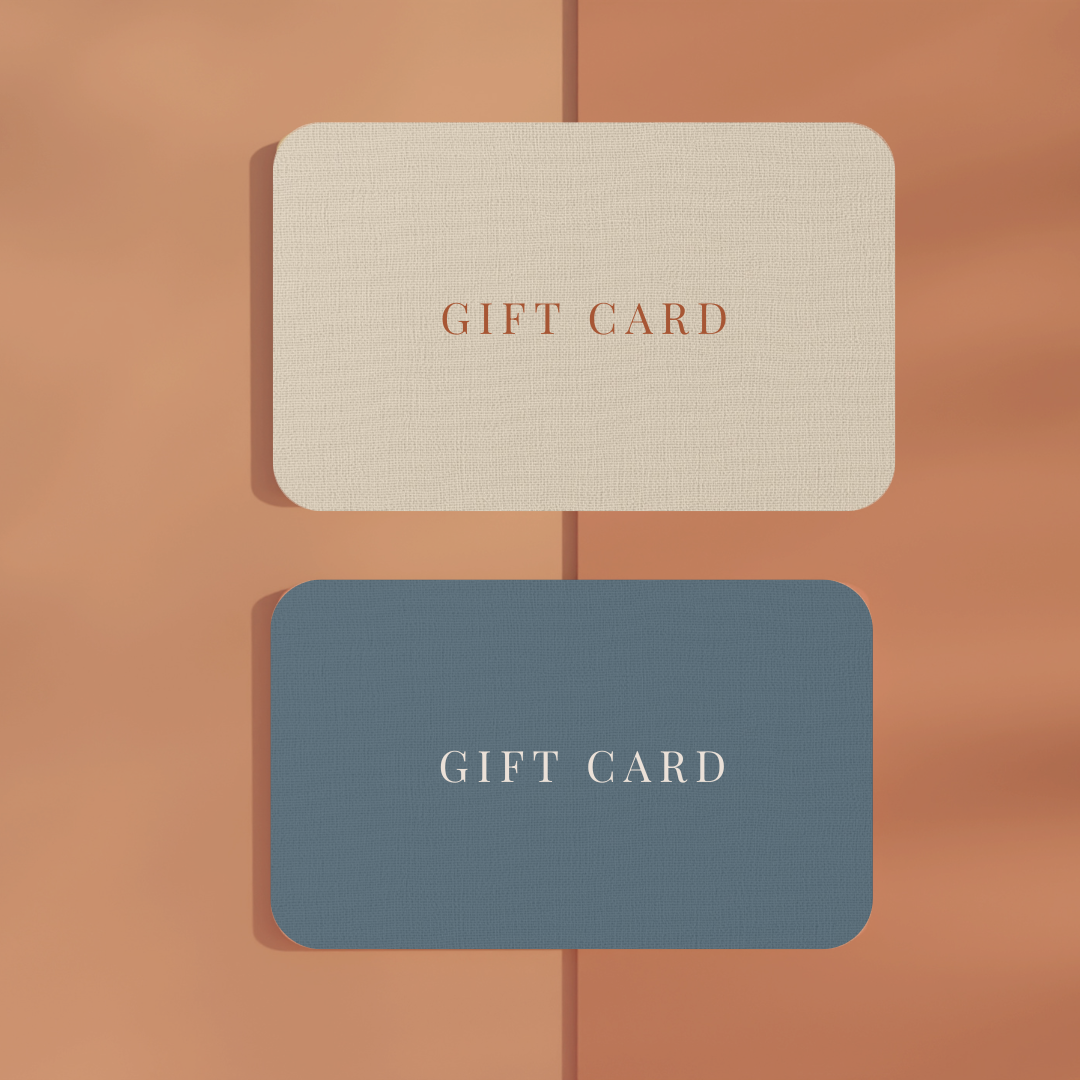 Two gift cards, one beige and one blue, on a brown background for Terri Madden Studio