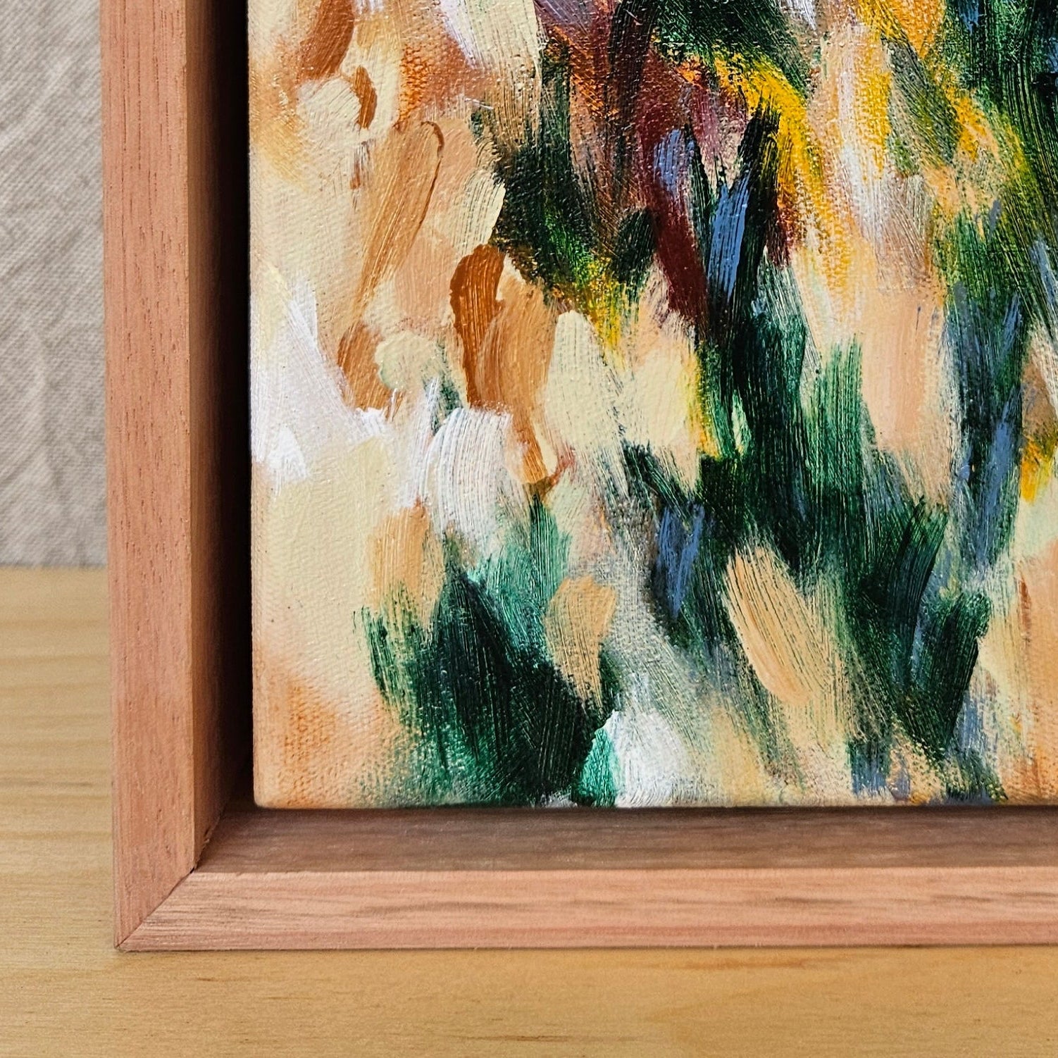 Close-up of a painting with visible brushstrokes and color details.